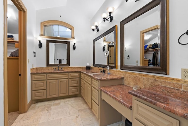 8212 Denali Pkwy, Austin, TX 78726 - bathroom with double vanity, a spacious closet, and stone tile floors
