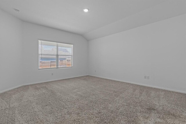 241 Madrid, Kyle, TX 78640 - spare room featuring carpet flooring, vaulted ceiling, baseboards, a smoke detector, and recessed lighting