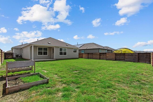 241 Madrid, Kyle, TX 78640 - back of house with central AC unit and a garden