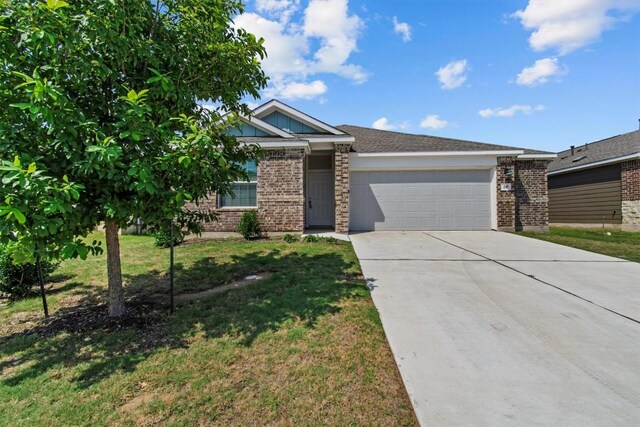 241 Madrid, Kyle, TX 78640 - view of front of property with a garage, brick siding, concrete driveway, and a front lawn