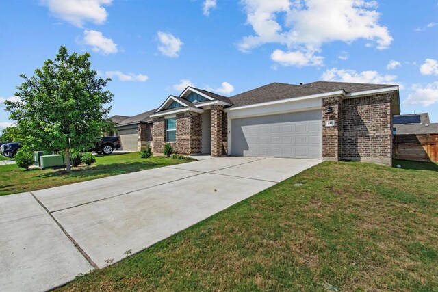 241 Madrid, Kyle, TX 78640 - view of front facade with brick siding, concrete driveway, and a garage