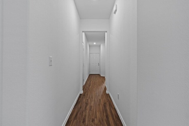 241 Madrid, Kyle, TX 78640 - hallway featuring dark wood finished floors and baseboards