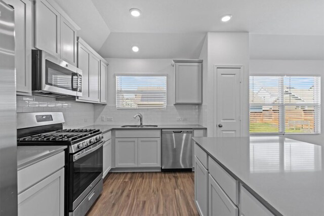 241 Madrid, Kyle, TX 78640 - kitchen featuring stainless steel appliances, a sink, dark wood finished floors, decorative backsplash, and recessed lighting