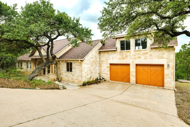 1608 Susan Dr, Austin, TX 78734 - view of front of property with stone siding, roof with shingles, and driveway