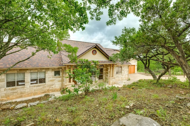 1608 Susan Dr, Austin, TX 78734 - view of front of house featuring stone siding, roof with shingles, and an attached garage