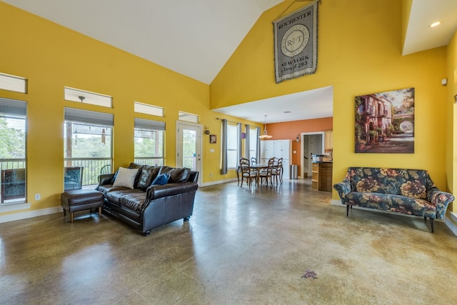 1608 Susan Dr, Austin, TX 78734 - living room with concrete flooring, high vaulted ceiling, baseboards, and a chandelier