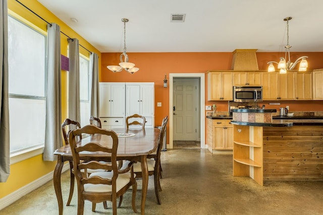 1608 Susan Dr, Austin, TX 78734 - dining room with a chandelier, baseboards, and concrete floors