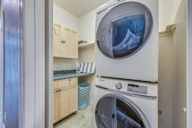 1608 Susan Dr, Austin, TX 78734 - washroom featuring stacked washer and clothes dryer, cabinet space, and baseboards