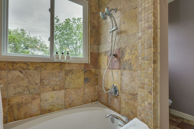1608 Susan Dr, Austin, TX 78734 - bathroom featuring toilet, tiled shower / bath, and baseboards