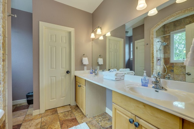 1608 Susan Dr, Austin, TX 78734 - full bathroom with tiled shower, double vanity, baseboards, and stone finish floors