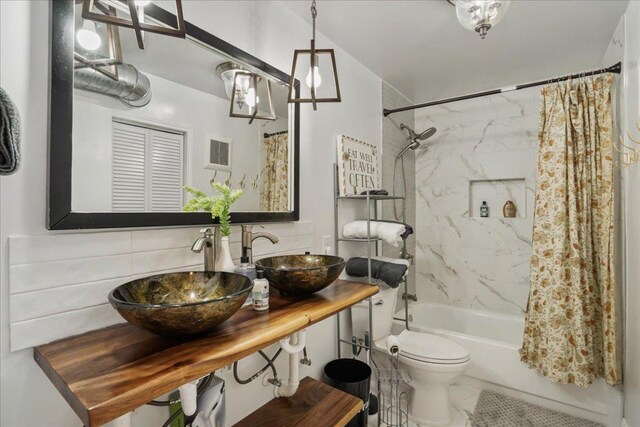 551 Demarett Dr Unit 4, Point Venture, TX 78645 - full bath with shower / tub combo, toilet, vanity, and backsplash