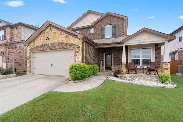 5627 Sabbia Dr, Round Rock, TX 78665 - view of front facade with a porch, a garage, a front yard, brick siding, and driveway