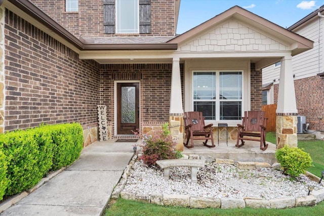 5627 Sabbia Dr, Round Rock, TX 78665 - view of exterior entry with brick siding and a porch
