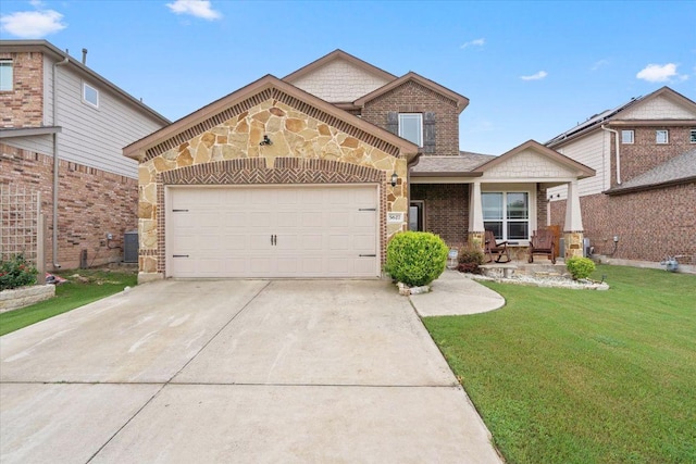 5627 Sabbia Dr, Round Rock, TX 78665 - view of front of house featuring a front lawn, driveway, a garage, brick siding, and stone siding