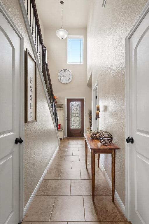 5627 Sabbia Dr, Round Rock, TX 78665 - entrance foyer featuring a high ceiling and stairway