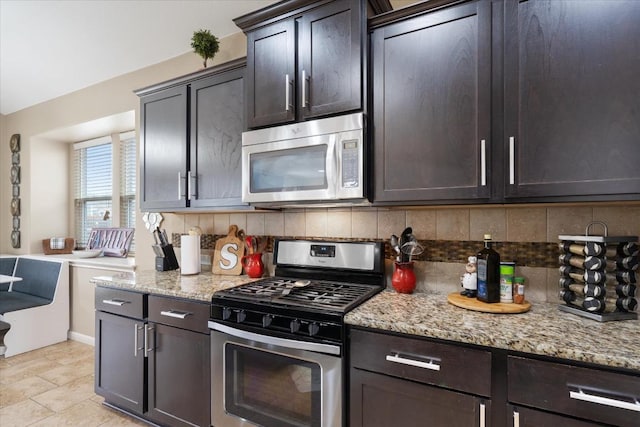 5627 Sabbia Dr, Round Rock, TX 78665 - kitchen with appliances with stainless steel finishes, decorative backsplash, light stone counters, and dark brown cabinetry
