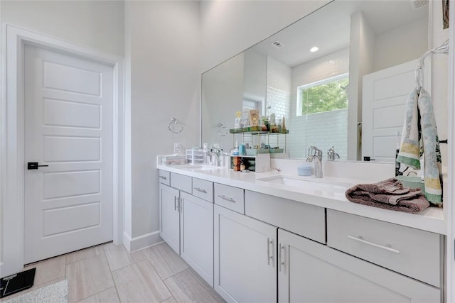 8414 Bowling Green Dr Unit 3, Austin, TX 78757 - bathroom featuring double vanity and baseboards