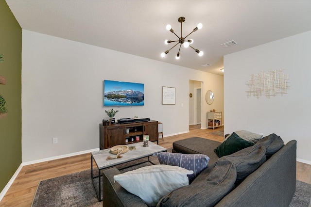 10204 Tildon Ave, Austin, TX 78754 - living room featuring a chandelier, light wood-style floors, and baseboards