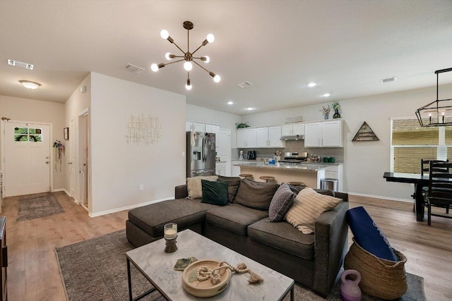 10204 Tildon Ave, Austin, TX 78754 - living room featuring a chandelier, light wood-type flooring, baseboards, and recessed lighting