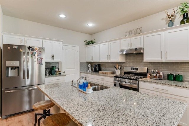 10204 Tildon Ave, Austin, TX 78754 - kitchen featuring stainless steel appliances, under cabinet range hood, white cabinets, and recessed lighting