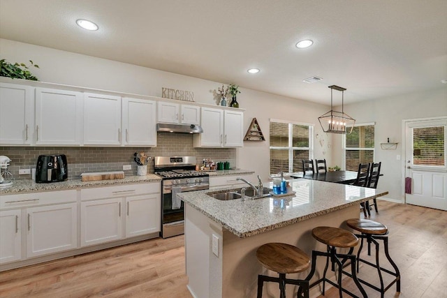 10204 Tildon Ave, Austin, TX 78754 - kitchen with gas stove, under cabinet range hood, a sink, light wood-type flooring, and recessed lighting