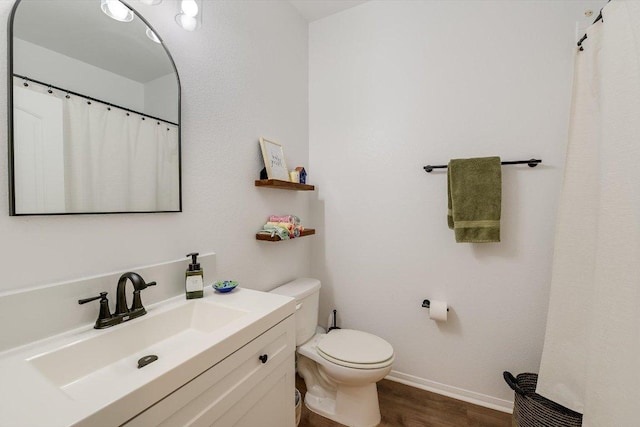 10204 Tildon Ave, Austin, TX 78754 - bathroom with vanity, wood finished floors, toilet, and baseboards