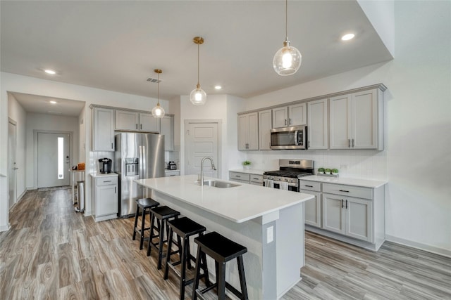 13901 Zuhause Dr, Pflugerville, TX 78660 - kitchen with appliances with stainless steel finishes, a sink, gray cabinetry, and recessed lighting