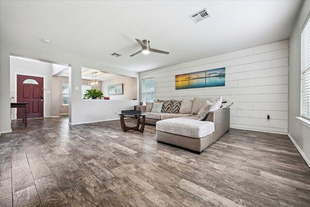 705 Camino Alto Dr, Leander, TX 78641 - living area with wood finished floors, ceiling fan, baseboards, and a chandelier