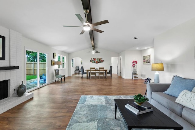 10802 Thicket Trl, Austin, TX 78750 - living area with a ceiling fan, arched walkways, wood finished floors, a fireplace, and baseboards