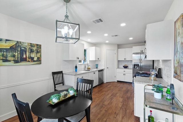 10802 Thicket Trl, Austin, TX 78750 - dining room featuring dark wood-style floors, a chandelier, recessed lighting, and baseboards