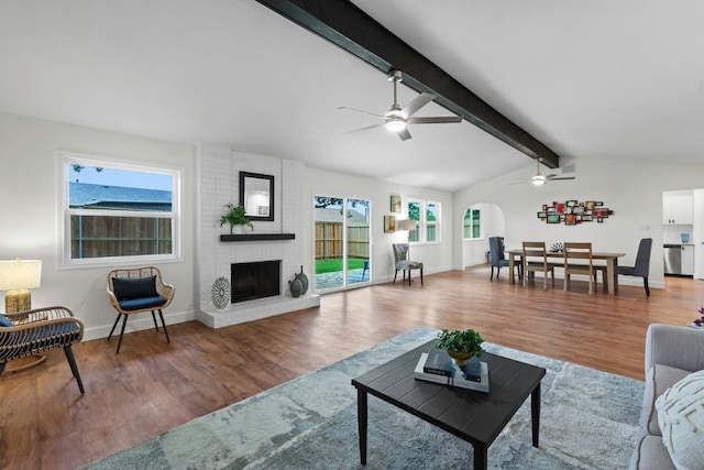 10802 Thicket Trl, Austin, TX 78750 - living area with ceiling fan, wood finished floors, a brick fireplace, and arched walkways