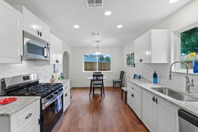 10802 Thicket Trl, Austin, TX 78750 - kitchen with appliances with stainless steel finishes, a sink, dark wood-style floors, decorative backsplash, and recessed lighting