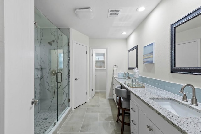 10802 Thicket Trl, Austin, TX 78750 - bathroom with a marble finish shower, double vanity, recessed lighting, and baseboards
