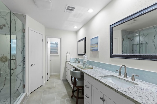 10802 Thicket Trl, Austin, TX 78750 - bathroom featuring a marble finish shower, double vanity, recessed lighting, and tile patterned flooring