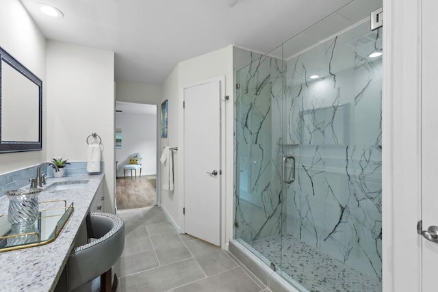 10802 Thicket Trl, Austin, TX 78750 - bathroom featuring a marble finish shower, vanity, and tile patterned flooring