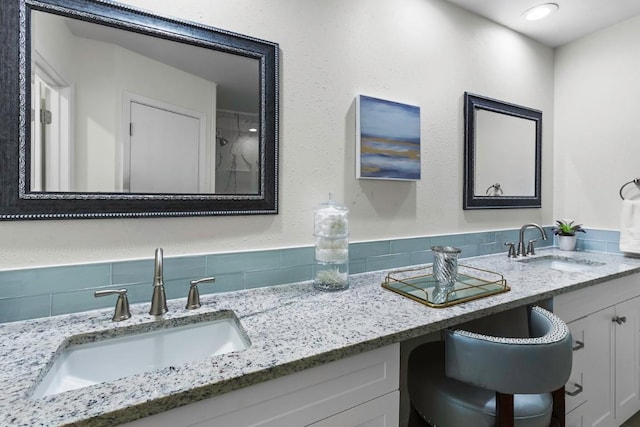 10802 Thicket Trl, Austin, TX 78750 - bathroom featuring double vanity and backsplash