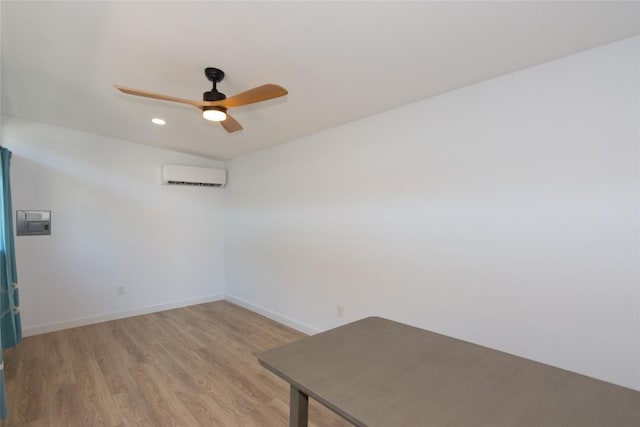 121 Split Oak Dr, Cedar Park, TX 78613 - empty room with a wall mounted air conditioner, ceiling fan, light wood-style flooring, and recessed lighting