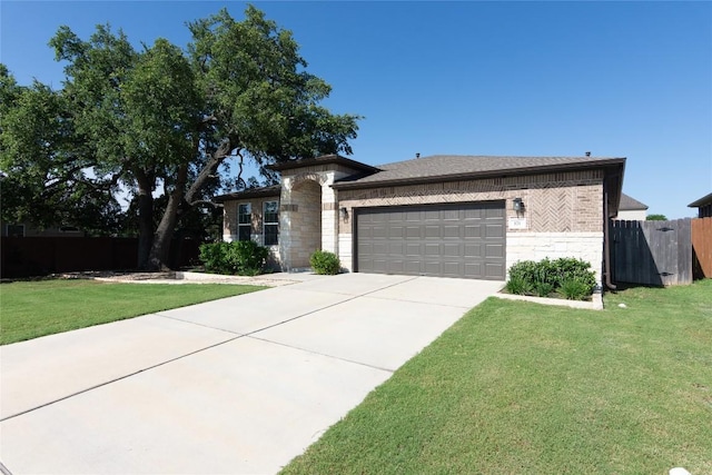 121 Split Oak Dr, Cedar Park, TX 78613 - view of front facade featuring stone siding, an attached garage, concrete driveway, and brick siding