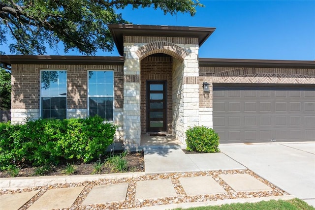 121 Split Oak Dr, Cedar Park, TX 78613 - view of front of house featuring brick siding, driveway, an attached garage, and stone siding
