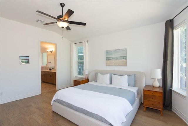 121 Split Oak Dr, Cedar Park, TX 78613 - bedroom featuring light wood-style flooring, baseboards, lofted ceiling, ensuite bath, and a ceiling fan