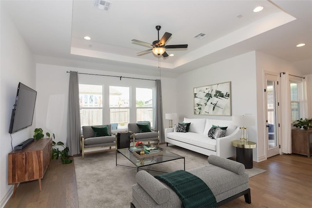 121 Split Oak Dr, Cedar Park, TX 78613 - living room featuring a raised ceiling, wood finished floors, a ceiling fan, recessed lighting, and baseboards