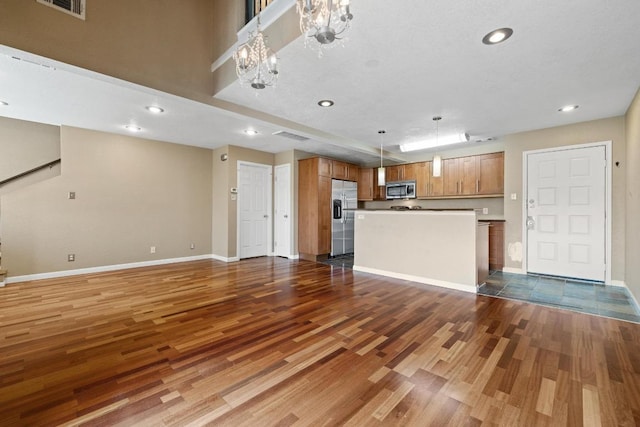 8888 Tallwood Dr Unit 1301, Austin, TX 78759 - unfurnished living room featuring wood finished floors, baseboards, recessed lighting, and a chandelier