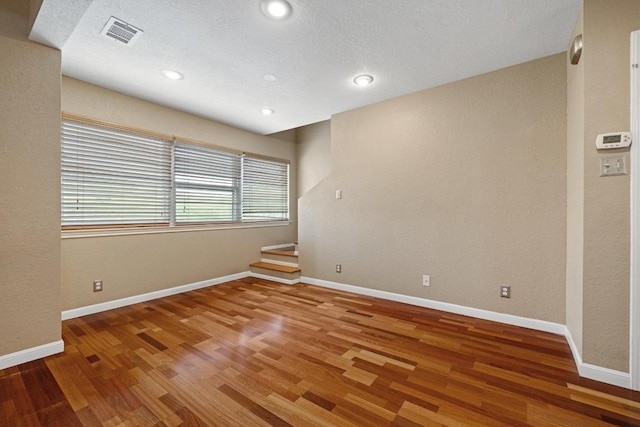 8888 Tallwood Dr Unit 1301, Austin, TX 78759 - empty room featuring wood finished floors and recessed lighting