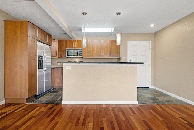 8888 Tallwood Dr Unit 1301, Austin, TX 78759 - kitchen featuring stainless steel appliances, dark wood-style flooring, brown cabinets, and pendant lighting