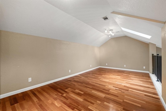 8888 Tallwood Dr Unit 1301, Austin, TX 78759 - bonus room with light wood-type flooring, vaulted ceiling, baseboards, and a skylight