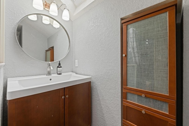 8888 Tallwood Dr Unit 1301, Austin, TX 78759 - bathroom with a textured wall and vanity