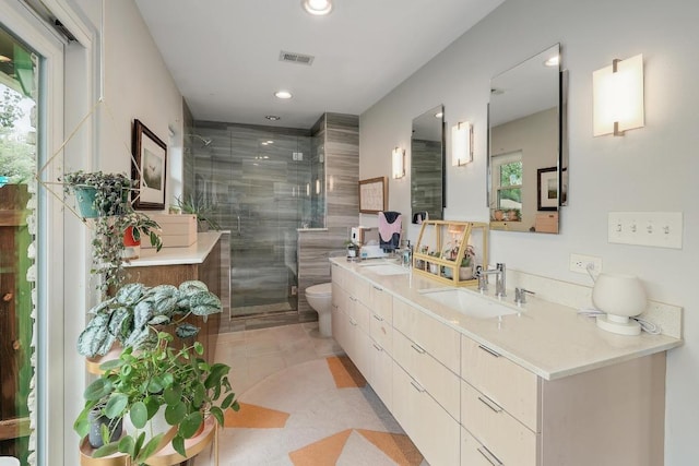 8701 Millway Dr, Austin, TX 78757 - bathroom with double vanity, a shower stall, toilet, plenty of natural light, and recessed lighting