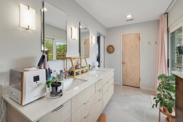 8701 Millway Dr, Austin, TX 78757 - bathroom featuring double vanity, tile patterned floors, recessed lighting, and baseboards