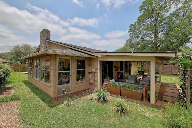 8701 Millway Dr, Austin, TX 78757 - rear view of house with a chimney, a sunroom, and a shingled roof