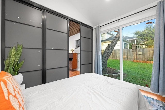 109 W 55th 1/2 St, Austin, TX 78751 - bedroom with access to outside, vaulted ceiling, and wood finished floors
